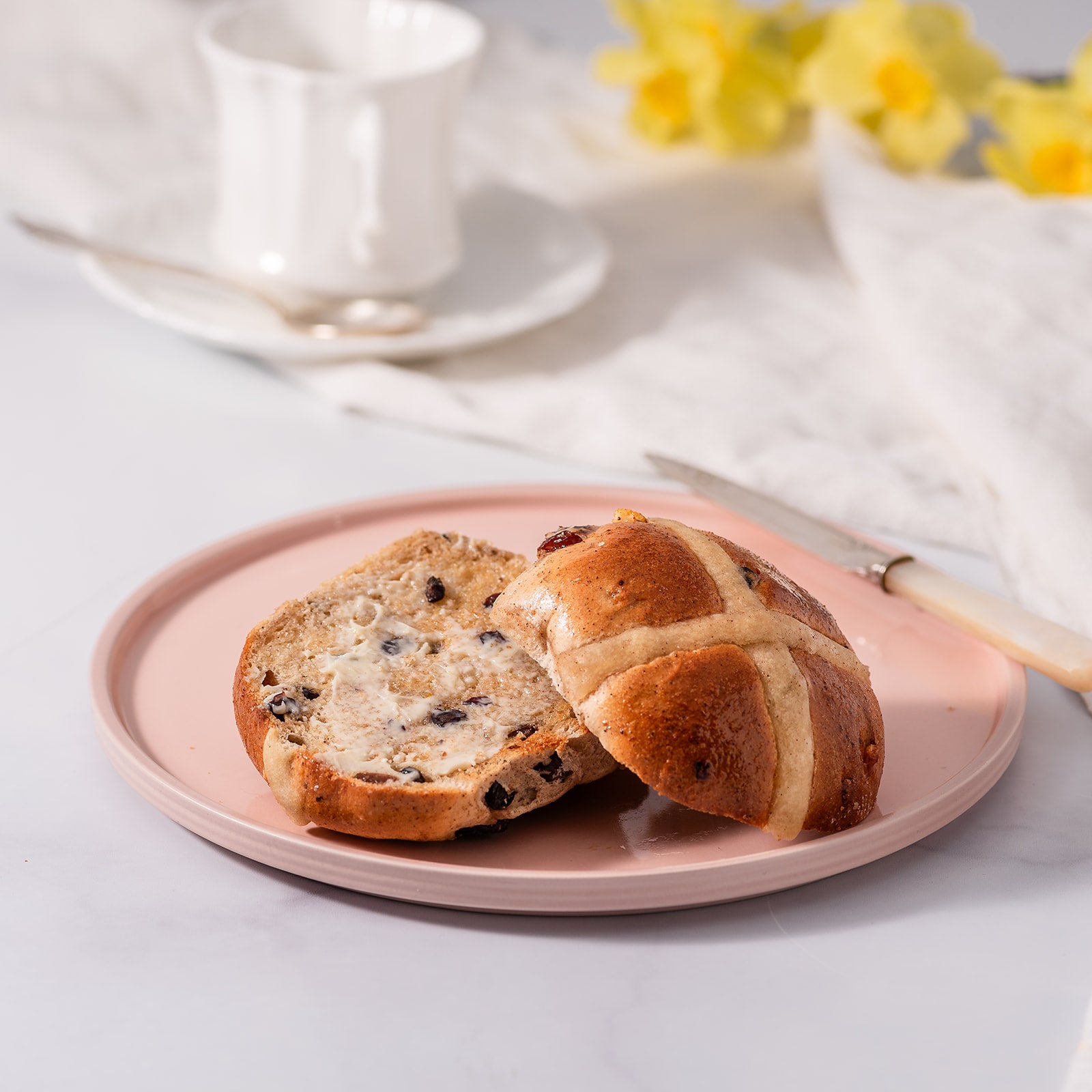 Toasted hot cross bun with melted butter