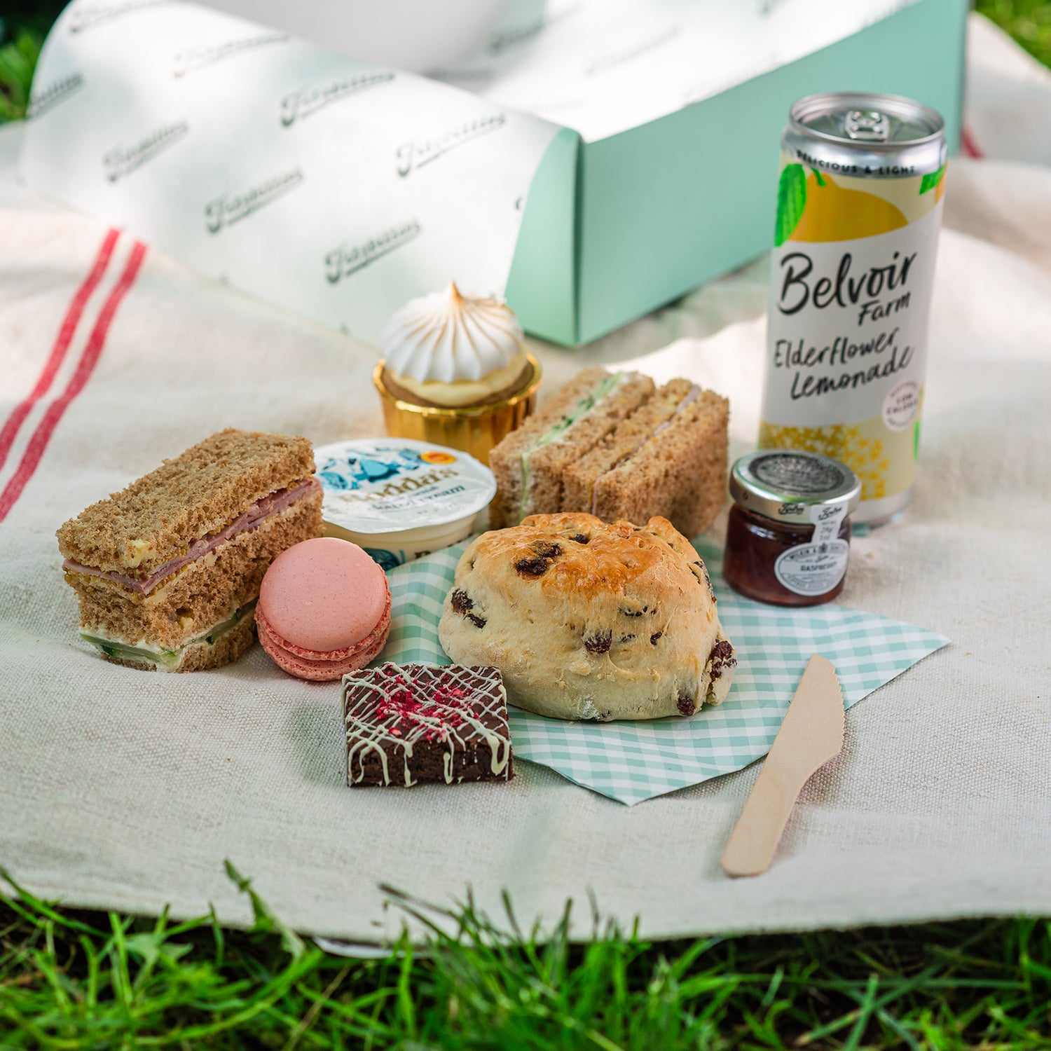 Afternoon tea picnic in Cambridge with finger sandwiches, scone and elderflower lemonade 