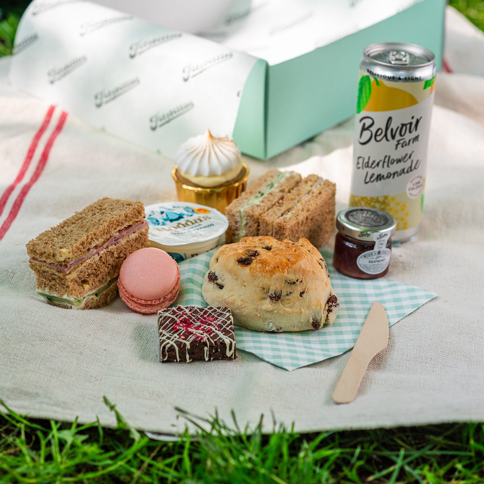 Afternoon tea picnic in Cambridge with finger sandwiches, scone and elderflower lemonade 