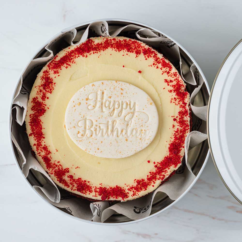 Red velvet postable cake with happy birthday plaque in a gift tin